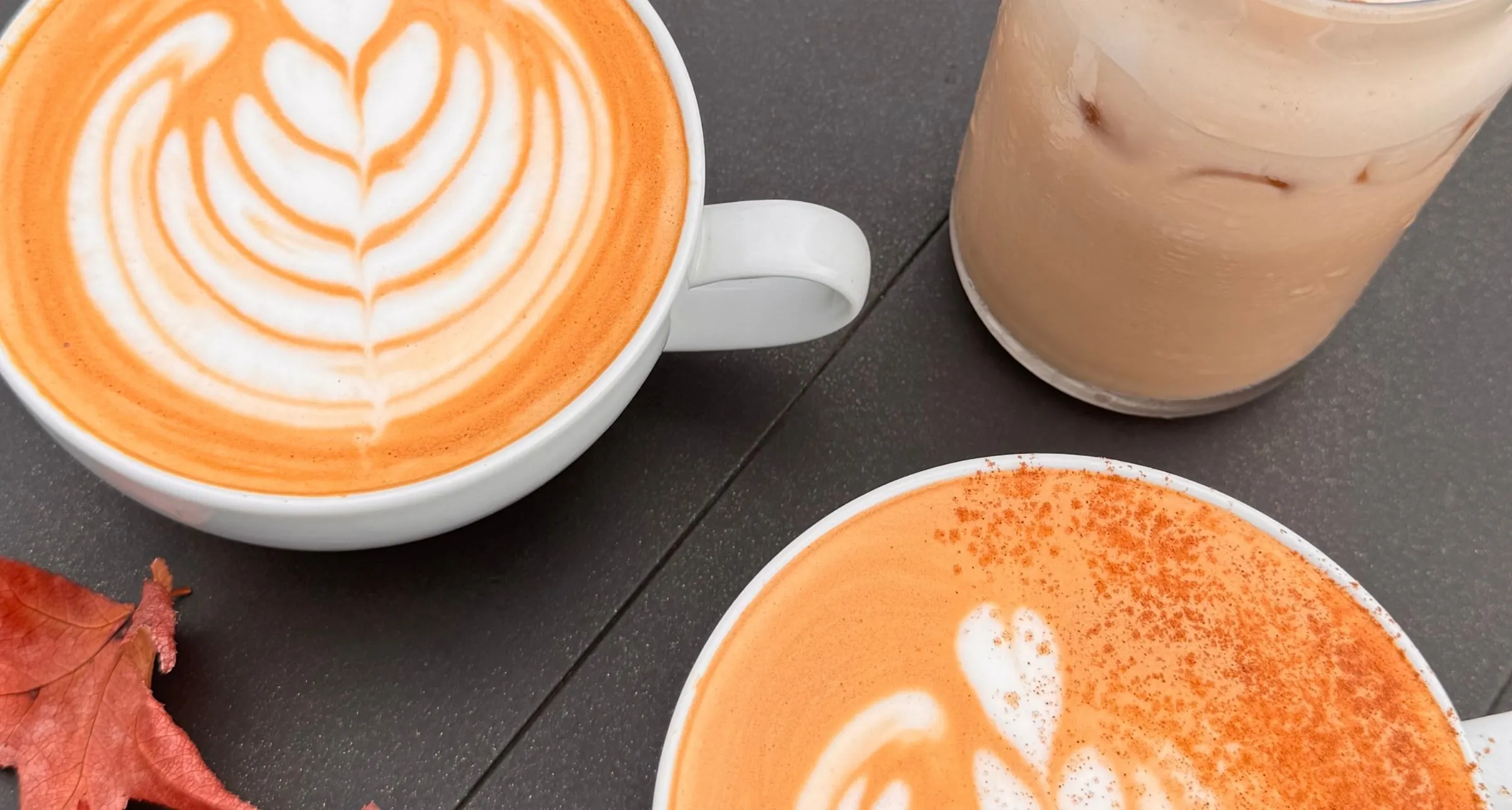 Fall lattes with rosetta latte art and an iced pumpkin chai dusted with cinnamon